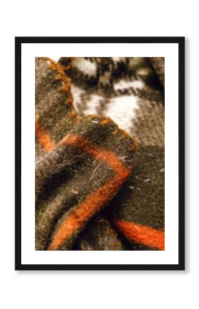 Moth larva on fabric — moving, damage, holes, cocoons, pests, household textiles, insect control. A close-up of a moth caterpillar moving across fabric.