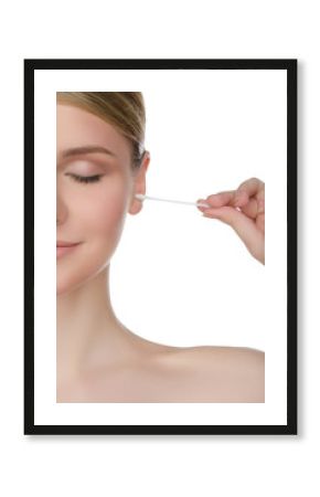 woman is cleaning ear with cotton swab
