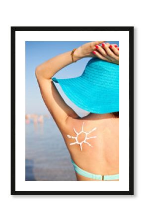 Woman With Suntan Lotion At The Beach In Form Of The Sun