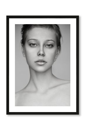 Beauty portrait of young blonde model with nude makeup. Black and white.