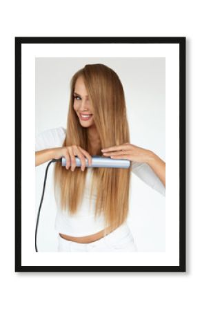 Beautiful Woman Ironing Long Straight Hair With Straightener