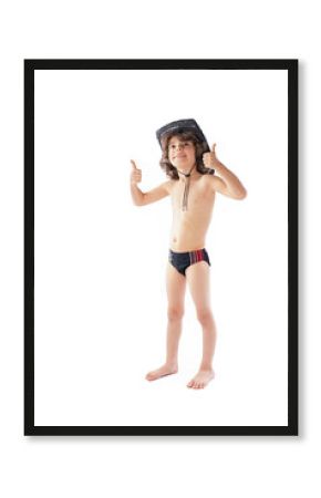 Little curly-haired cowboy hat and bathing suit standing and looking at the camera. Gray background.