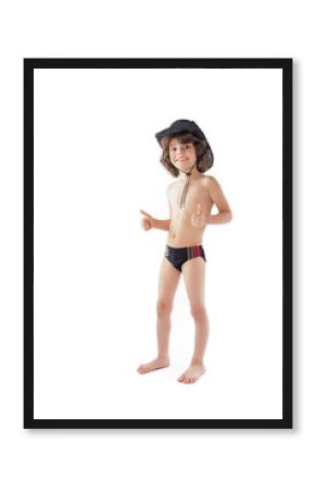 Little curly-haired cowboy hat and bathing suit standing and looking at the camera. Gray background.
