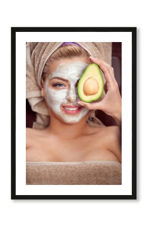 Beautiful spa woman in avocado facial mask