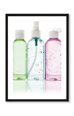 three toiletry bottles with water droplets on white background