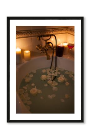 Take a bath with rose petals and candles. Romantic evening in the bathroom with wine and candles