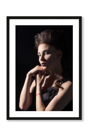 Portrait of girl with hands on black background