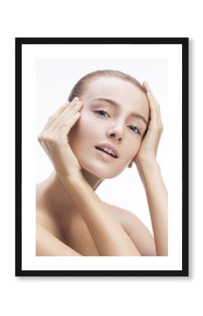 Close-up beauty shot of a beautiful young blonde women with sensuality in the eyes.   Focus on face and nice shiny skin. 