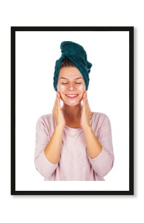 Woman with bathtowel appying face cream