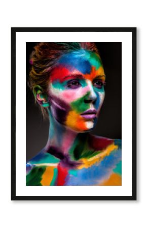 Fashion model girl portrait with colorful paint make up. Sexy woman bright color makeup. Art design. Grey background