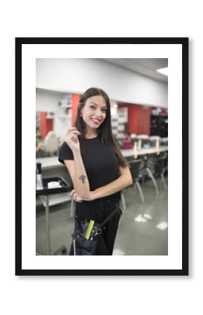 Woman with scissors posing in barber shop