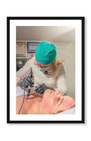 Beautician performs a needle mesotherapy treatment on a woman face.