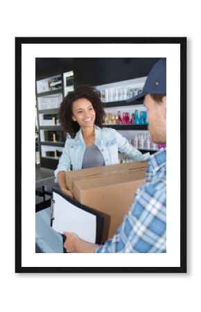 customer receiving a delivery in her hairdresser salon