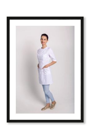 doctor beautician in a white robe is in the Studio