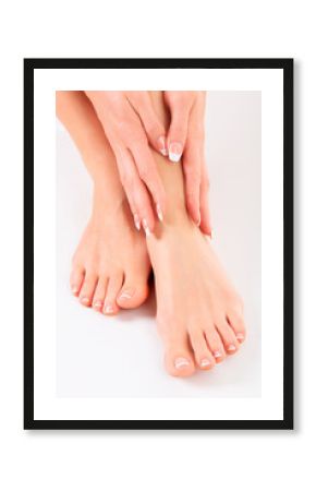 Well-groomed hands on female feet