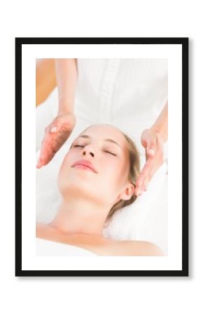  Calm woman receiving reiki treatment