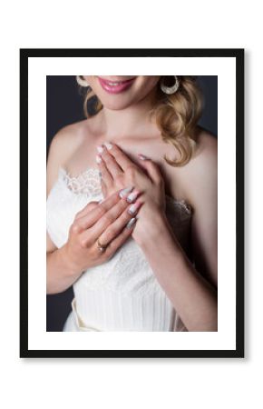 hand beautiful girl bride in white wedding dress with acrylic nails and delicate pattern and rhinestones