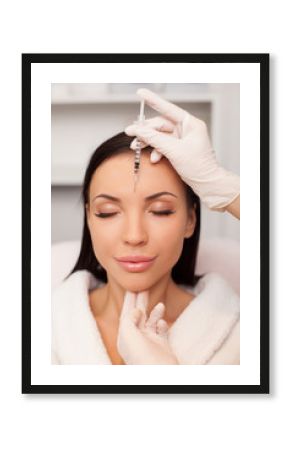 Cheerful young lady is visiting her cosmetologist