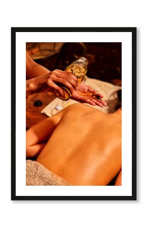 Woman having Ayurveda massage with herbal ball.