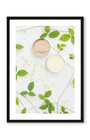 Top view of natural organic beauty cream with bath salt and leaves