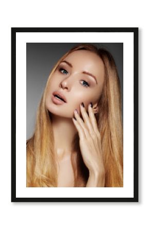 Beautiful young woman with clean skin, beautiful straight shiny hair, fashion makeup. Glamour make-up, perfect shape eyebrows. Portrait sexy blondy. Beautiful smooth hairstyle. Shiny nail polish    