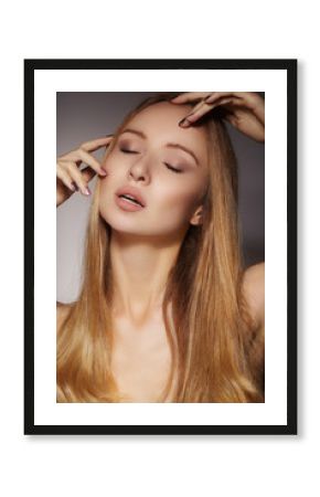 Beautiful young woman with clean skin, beautiful straight shiny hair, fashion makeup. Glamour make-up, perfect shape eyebrows. Portrait sexy blondy. Beautiful smooth hairstyle. Shiny nail polish