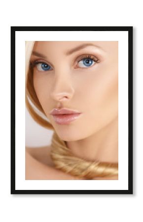 Beauty fashion model girl with perfect face skin Portrait. Beautiful blonde Isolated on white. Natural make-up, blue eyes, pink gloss on her lips, long eyelashes