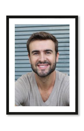 Attractive man face portrait with a white perfect smile isolated on a gray background