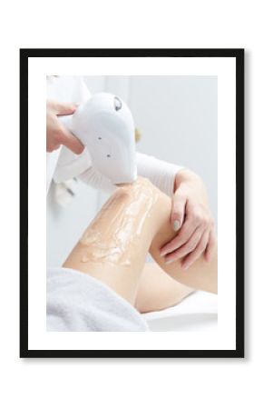 Beautician Giving Epilation Laser Treatment To Woman On Thigh