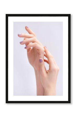 Closeup of hands of a young woman with pink manicure on nails