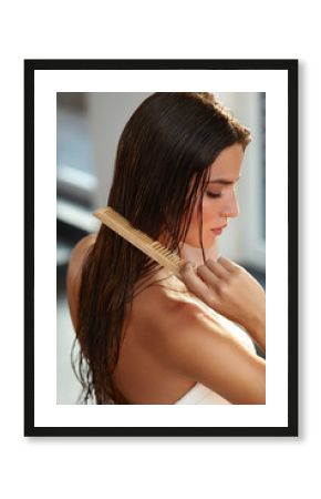 Beautiful Woman Hairbrushing Her Long Wet Hair. Hair Care