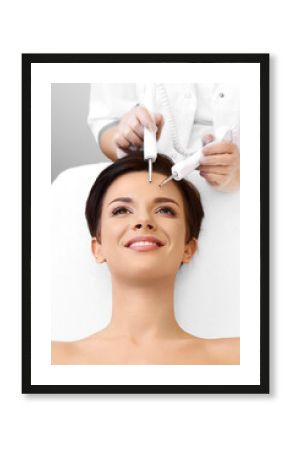 Cosmetology. Spa clinic. Beautiful woman at facial treatment procedure. Young healthy skin. Facial mask. Skin rejuvenation.