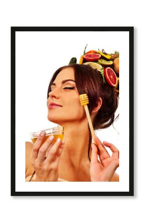 Honey facial mask with fresh fruits for hair and skin on woman head. Girl face hold honeycombs for homemade organic skin and hair therapy. Medical properties of honey concept. Popular masks for face.