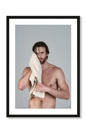 Man in bathroom with muscular body on grey background.