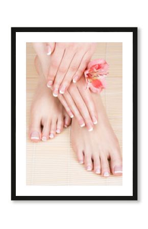 female feet at spa salon on pedicure and manicure procedure