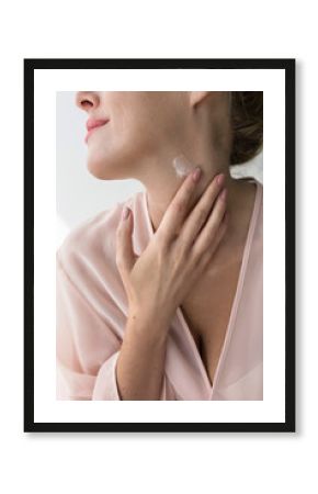 Woman Applying Creme on Her Neck