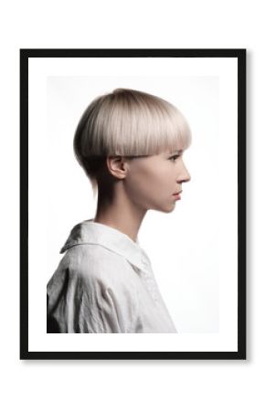 Girl model blonde posing on white background. Short dyed hair, haircut, smooth bangs. White shirt.