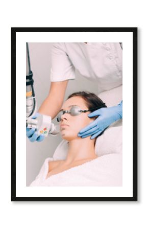 woman getting laser facial treatment, aesthetic surgery,