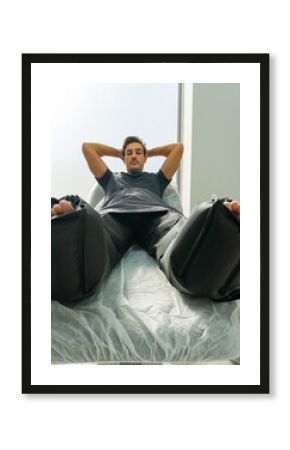 patient lying on a stretcher with air compression pants