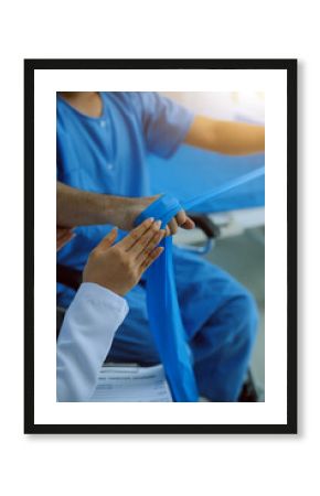 Physical therapist guiding patient with resistance band