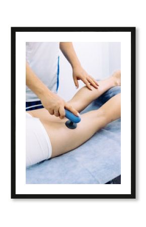 A doctor administers magnetic therapy to a young woman, targeting muscle recovery post-injury. Ideal for showcasing advanced physiotherapy treatments that accelerate healing and restore function.