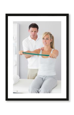 Attractive physiotherapist massaging patient