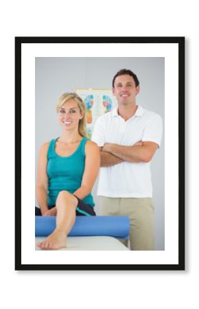 Attractive physiotherapist and patient posing for camera