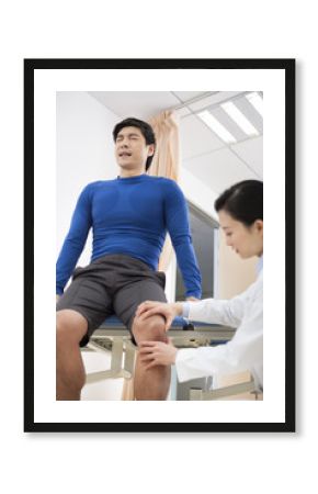 Doctor examining patient's leg