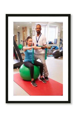 Female Patient Working With Physiotherapist In Hospital