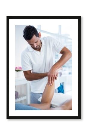 Physiotherapist giving leg massage to a woman