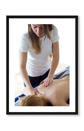 Young physiotherapist doing a back treatment to the patient in a physiotherapy room.