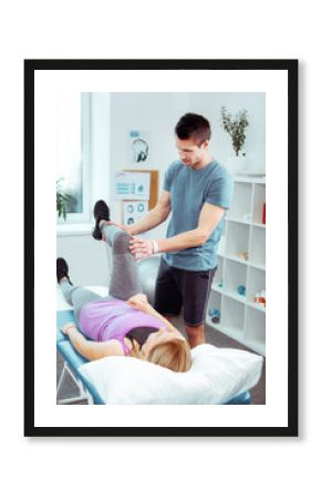 Serious young man standing near his patient