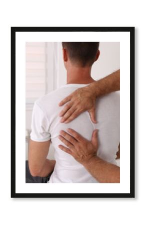 Back pain , Physiotherapy. Man Chiropractic pain relief adjustment /Kinesiology treatment . Osteopathy practitioner