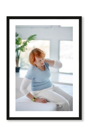 Tired aged woman feeling a strong pain